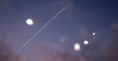 This photo shows rocket trails and intercepts in the sky over the Israeli city of Netanya, June 14, 2025. (AFP Photo)