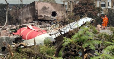 Officials inspect the remains of the Air India passenger plane at the crash site near Sardar Vallabhbhai Patel International Airport in Ahmedabad, Gujarat state, western India, June 14, 2025. (EPA Photo)