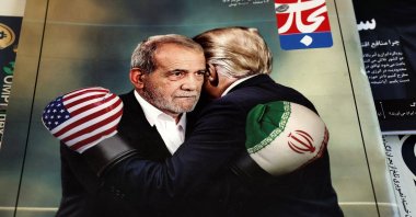 A copy of the Iranian magazine Tejarat Farda, titled &quot;The benefit of peace,&quot; features an image of Iranian President Masoud Pezeshkian and U.S. President Donald Trump embracing while wearing boxing gloves at a kiosk, Tehran, Iran, June 3, 2025. (EPA Photo)