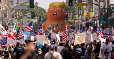 A balloon of U.S. President Donald Trump in a diaper is seen among people taking part in a "No Kings" protest in Los Angeles, California, June 14, 2025. (AFP Photo)