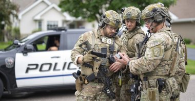 Armed FBI agents have a meeting to strategize as they search for an active shooter in Brooklyn Park, Minnesota, U.S., June 14, 2025. (AP Photo)