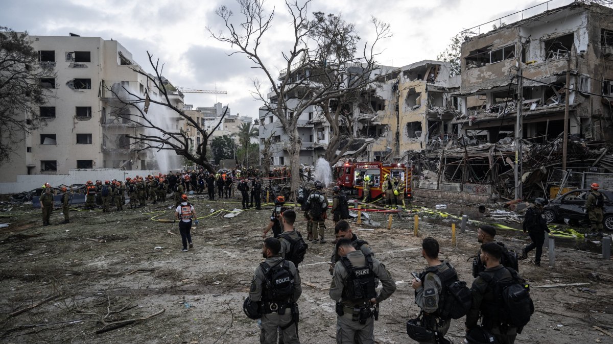 Rescuers work near damaged buildings following a strike by an Iranian missile in Tel Aviv, Israel, June 16, 2025. (AA Photo)