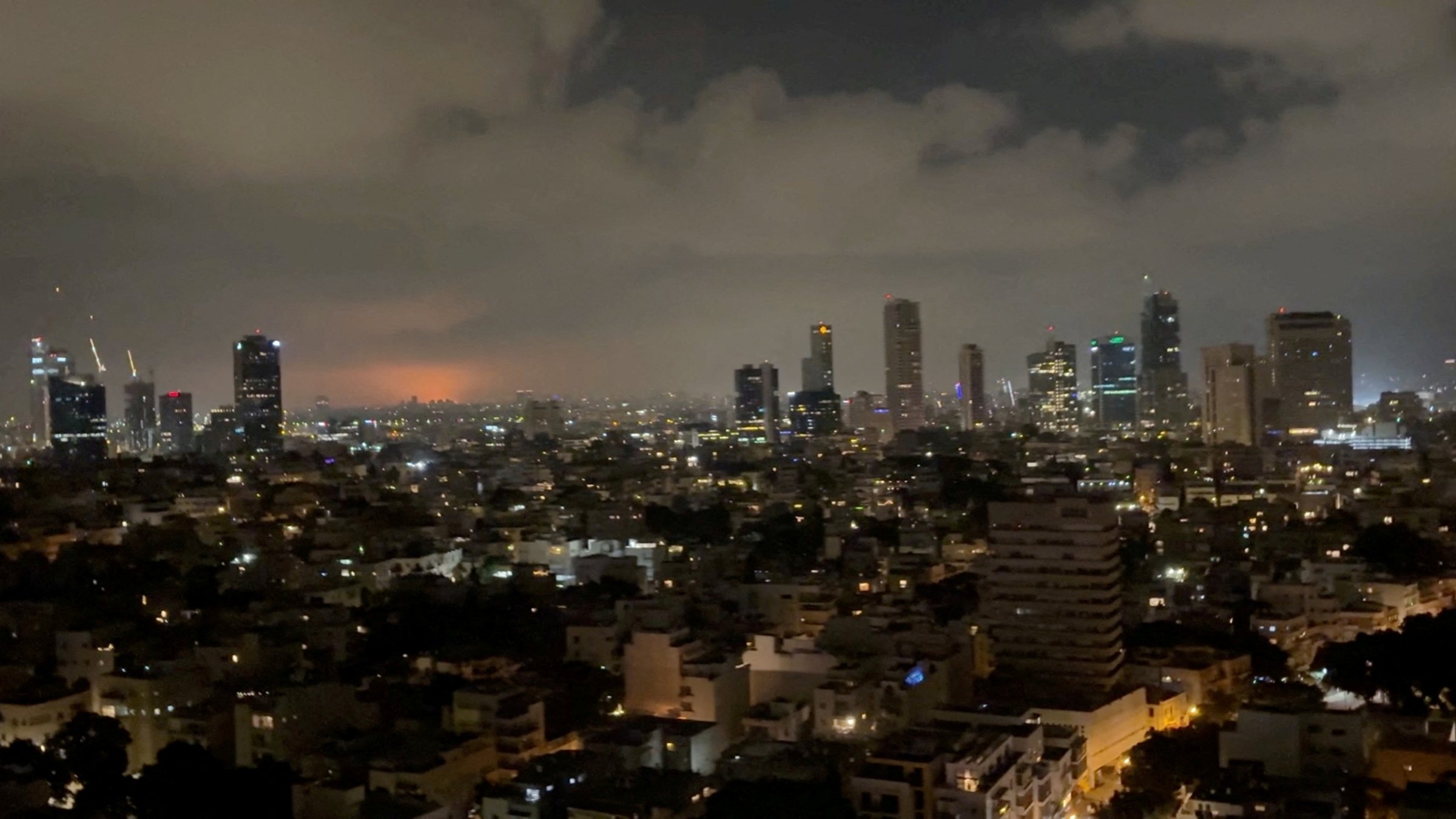 A rocket explosion lights up the sky in Tel Aviv, Israel, June 15, 2025. (Ran Goldman/via Reuters)