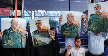 People hold up pictures of slain Islamic Revolutionary Guard Corps (IRGC) commanders (L to R) Hossein Salami, Mohammad Bagheri, Gholam Ali Rashid and Amir Ali Hajizadeh, who were killed by recent Israeli strikes, as they attend a rally in solidarity with the Iranian government, Enghelab (Revolution) Square, Tehran, Iran, June 14, 2025. (AFP Photo)