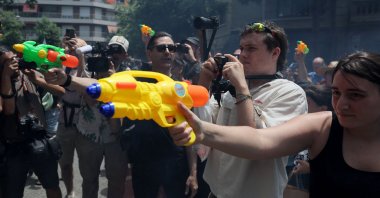 Protesters spray water at a hotel using toy water guns during a demonstration against mass tourism in Barcelona, Spain, June 15, 2025. (AFP Photo)