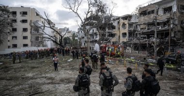 Rescuers work near damaged buildings following a strike by an Iranian missile in Tel Aviv, Israel, June 16, 2025. (AA Photo)