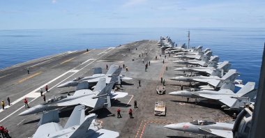 This handout grab taken from footage released by the US Defence Visual Information Distribution Service (DVIDS) on June 11, 2025 shows the aircraft carrier USS Nimitz (CVN 68) conducting flight operations in the South China Sea, May 28, 2025. (AFP Photo)