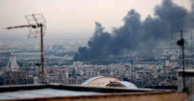 Smoke billows from an explosion near the Azadi Tower (L) in Tehran on June 16, 2025. (AFP Photo)