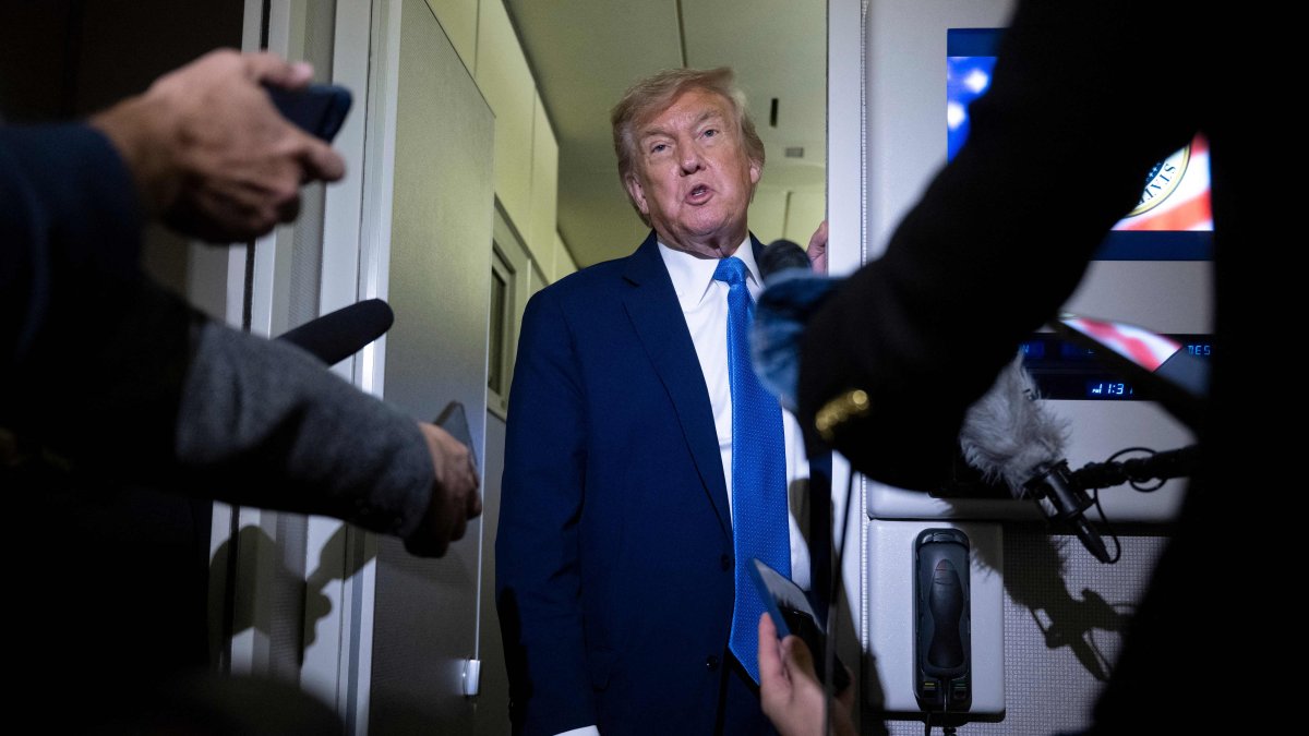 U.S. President Donald Trump speaks to reporters aboard Air Force One while traveling back to Washington from Canada, June 16, 2025. (AFP Photo)