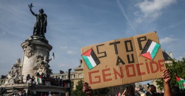 A demonstrator holds a placard reading &quot;Stop the Genocide&quot; during a solidarity rally for Gaza and Palestine at the Place de la Republique, Paris, France, June 9, 2025. (EPA Photo)