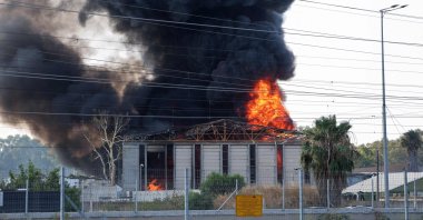 Smoke billows from a fire in a building in Herzliya following a fresh barrage of Iranian rockets, near Tel Aviv, Israel, June 17, 2025. (AFP Photo)