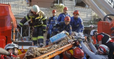 Ukrainian rescuers evacuate an injured elderly woman from the site of an airstrike on a nine-story residential building in Kyiv, Ukraine, June 17, 2025. (EPA Photo)