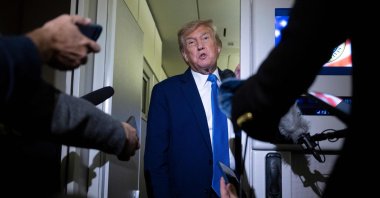 U.S. President Donald Trump speaks to reporters aboard Air Force One while traveling back to Washington from Canada, June 16, 2025. (AFP Photo)