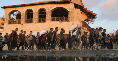 Palestinians walk carrying aid supplies in Beit Lahia, northern Gaza Strip, Palestine, June 17, 2025. (Reuters Photo)