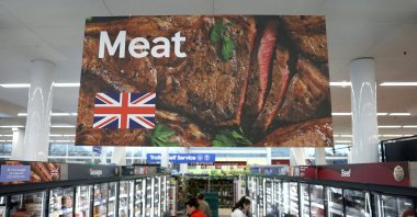 People shop along a meat aisle at a Tesco Extra supermarket, Cheshunt, U.K., March 25, 2025. (Reuters Photo)