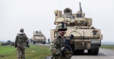 A soldier from the U.S.-led coalition stands guard during a patrol in the countryside of Qamishli, northeastern Syria, Feb. 8, 2024. (Reuters Photo)