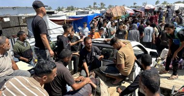  Palestinians evacuate a wounded man amid long queues for receiving humanitarian aid in the southern Gaza city of Rafah, June 15, 2025. (AFP Photo)