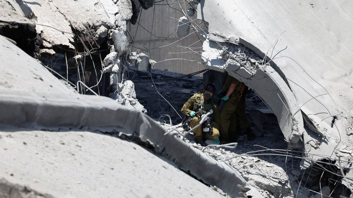 Emergency workers inspect an impact site at Soroka Medical Center, in Beersheba, Israel, June 19, 2025. (Reuters Photo)