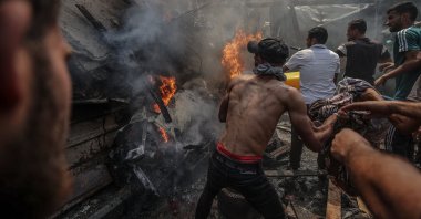 Palestinians try to put out a fire caused by Israeli strikes in the Shati refugee camp, western Gaza, Palestine, June 19, 2025. (AA Photo)