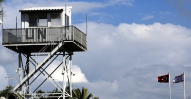 A U.N. guard post at the U.N. controlled area is seen near Turkish and Turkish Cypriot flags in Lefkoşa (Nicosia), TRNC, March 15, 2023. (AP Photo)