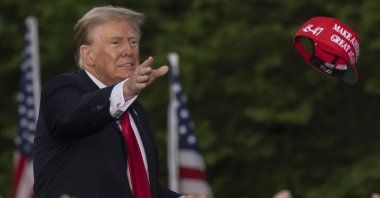 Donald Trump throws a &quot;MAGA&quot; hat during a campaign rally in the south Bronx, New York, U.S., May. 23, 2024. (AP Photo)