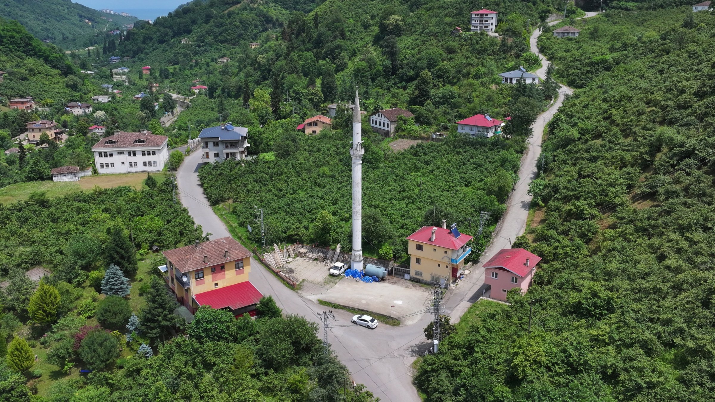 An aerial view shows the lone minaret standing tall, symbolizing the neighborhood’s history amid changing landscapes in Yomra, Trabzon, Türkiye, June 17, 2025. (AA Photo)