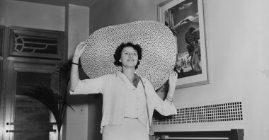 Heiress Peggy Guggenheim wears a large brimmed hat, aboard the Atlantic Clipper, as she arrives in New York City from France. (Getty Images)