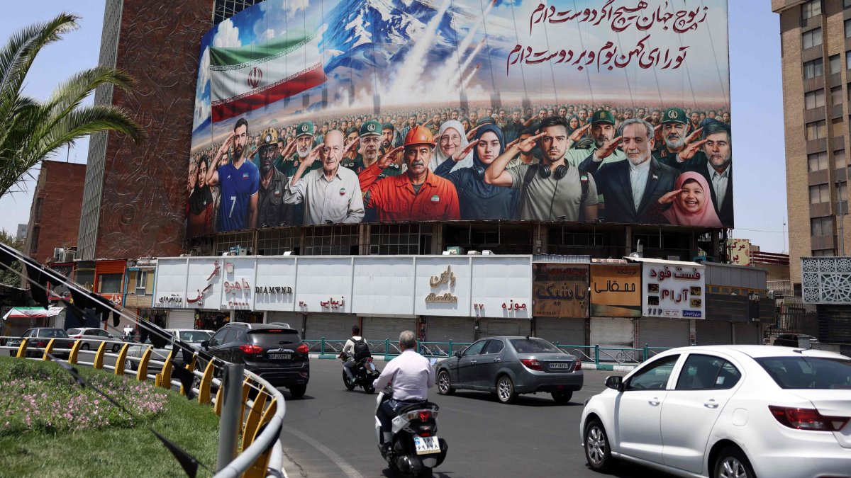 A banner bearing a painting that represents various categories of the Iranian society, with a message that reads in Farsi: "We are all soldiers of Iran," Tehran, Iran, June 22, 2025. (AFP Photo)
