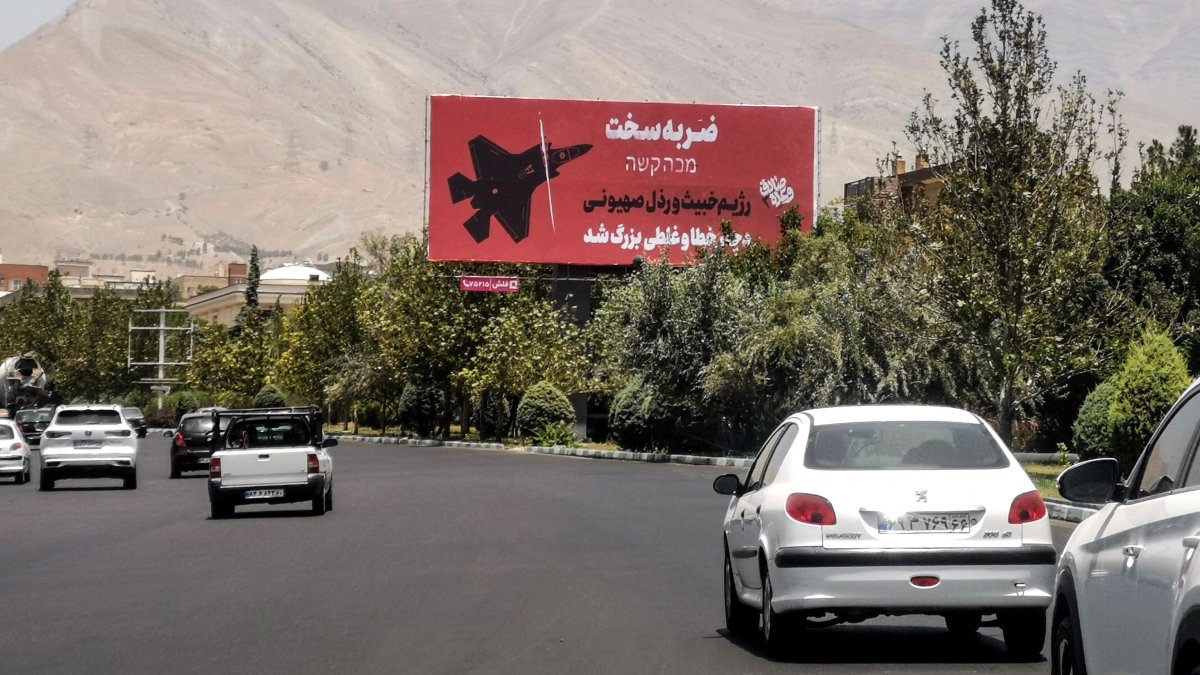 Commuters drive past an anti-Israel billboard in Tehran, Iran, June 22, 2025. (AFP Photo)