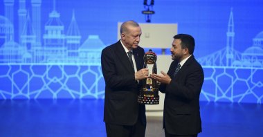 President Recep Tayyip Erdoğan receives the Grand Youth Award from ICYF Chair Taha Ayhan, Istanbul, Türkiye, June 20, 2025. (AA Photo)
