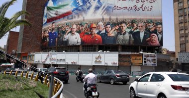 A banner bearing a painting that represents various categories of the Iranian society, with a message that reads in Farsi: "We are all soldiers of Iran," Tehran, Iran, June 22, 2025. (AFP Photo)