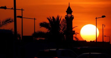 The sun sets near a mosque in Doha, Qatar, June 21, 2025. (AFP Photo)