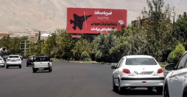 Commuters drive past an anti-Israel billboard in Tehran, Iran, June 22, 2025. (AFP Photo)