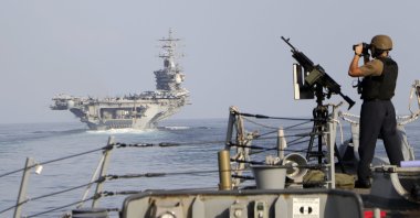 The aircraft carrier USS Dwight D. Eisenhower and other warships cross the Strait of Hormuz into the Persian Gulf Nov. 26, 2023. (AP Photo)