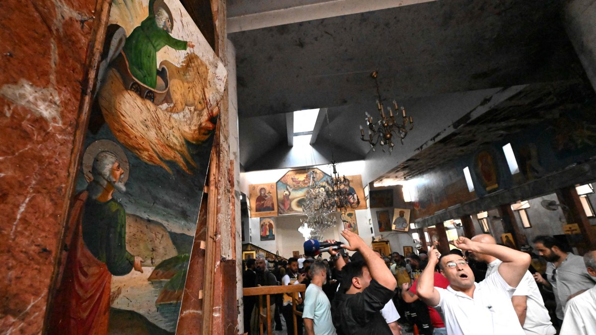People and rescuers inspect the damage at the site of a reported suicide attack at the Saint Elias church in Damascus&#039; Dwelaa area, Syria, June 22, 2025. (AFP Photo)
