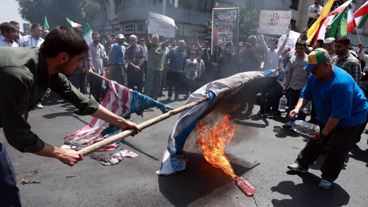 Iranians burn U.S. and Israeli flags during an anti-Israel rally, Tehran, Iran, June 20, 2025. (EPA Photo)