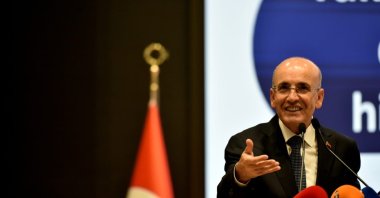 Treasury and Finance Minister Mehmet Şimşek gestures as he delivers a presentation on economic outlook, Lefkoşa (Nicosia), Turkish Republic of Northern Cyprus (TRNC), May 27, 2025. (IHA Photo)