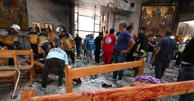 People and rescuers inspect the damage at the site of a reported suicide attack at the Saint Elias church in the Dwelaa area, Damascus, Syria, June 22, 2025. (AFP Photo)