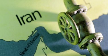 A map showing the Strait of Hormuz and Iran is seen behind a 3D printed oil pipeline in this illustration taken June 22, 2025. (Reuters Photo)