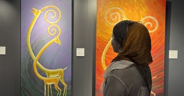 A visitor explores the artworks by Ömer Onay at AKM, Istanbul, Türkiye, June 16, 2025. (AA Photo)