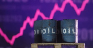 A rising stock graph and 3D printed oil barrels are seen in this illustration taken on June 23, 2025. (Reuters Photo)