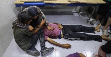 Palestinians mourn by the body of a relative killed in Israeli fire at a food aid distribution point set up by the GHF, near Nuseirat, central Gaza, Palestine, June 24, 2025. (AFP Photo)