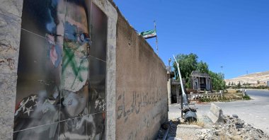 A defaced portrait of the late Hafez Assad, the father of the ousted former regime leader Bashar Assad, hangs on a wall, Damascus, Syria, June 2, 2025. (AFP Photo)