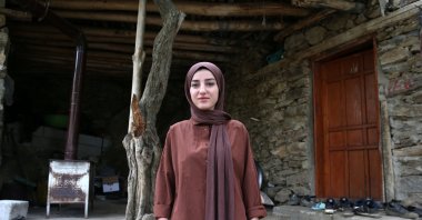 Melek Okur, 23, stands outside the village office after becoming the only female mukhtar in Hizan district of Bitlis, Türkiye, June 12, 2025. (AA Photo)
