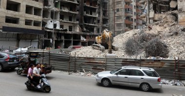 Cars and motorbikes drive near damaged buildings in Beirut southern suburbs, Lebanon, June 23, 2025. (Reuters Photo)