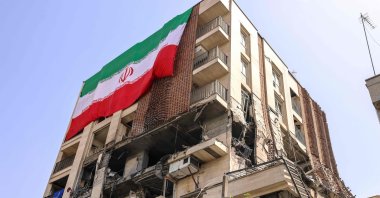 This picture shows a residential building that was hit in an Israeli strike covered with a big Iranian flag, Tehran, Iran, June 25, 2025. (AFP Photo)