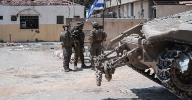 Israeli soldiers stand in front of an entrance to the European Hospital, during a controlled embed organized by the Israeli military in Khan Younis, southern Gaza Strip. June 8, 2025. (AFP Photo)