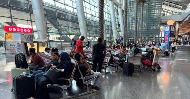 People sit at Hamad International Airport after Qatar reopened its airspace following a brief closure in the wake of Iran’s missile attack on Al Udeid Air Base on Monday, in Doha, Qatar, June 24, 2025. (Reuters Photo)