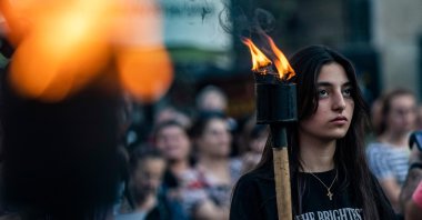 Christian Syrians carry torches during a march to express support with the families of victims of a suicide attack on a church in Damascus on the weekend, Qamishli, Syria, June 25, 2025, (AFP Photo)