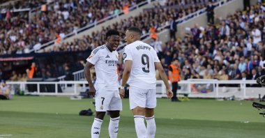 Real Madrid&#039;s Vinicius Junior (L) and Kylian Mbappe celebrate after a goal during the La Liga match against Barcelona, Barcelona, Spain, May 11, 2025. (AP Photo)
